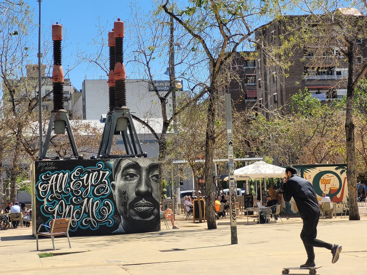 Small city patio with the locals and 2Pac graffiti